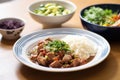 plated feijoada with slices of pork, visible bean stew