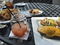 Plated grilled fish dinner with sides and a Bloody Mary. Royalty Free Stock Photo