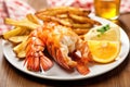 plated grilled lobster tails alongside golden french fries Royalty Free Stock Photo