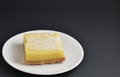 Plated Lemon Bar with white powdered sugar