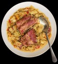 Plateful Of Cabbage Cooked With Smoked Pork Ribs Served With Dinner Spoon On Black Background Royalty Free Stock Photo