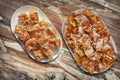 Plateful Of Cheese Pie Gibanica and Spit Roasted Pork Meat Slices Set On Old Garden Table