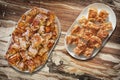 Plateful Of Cheese Pie Gibanica and Spit Roasted Pork Meat Slices Set On Old Garden Table