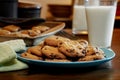 Plateful of chocolate chip cookies fresh and warm out of the oven with cold glass of milk Royalty Free Stock Photo