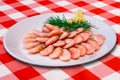 Plateful of cooked shrimps with lemon slice on checked tablecloth Royalty Free Stock Photo