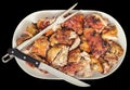 Plateful of Fresh Spit Roasted Pork Meat Slices with Serving Knife and Fork on Oval Porcelain Tray Isolated on Black Background Royalty Free Stock Photo