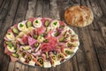 Plateful Of Traditional Serbian Appetizer Savory Dish Meze With Pitta Bread And Tomato Set On Old Garden Table Surface Royalty Free Stock Photo