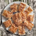 Serbian Traditional Crumpled Cheese Pie Gibanica Slices Served On White Porcelain Plate Set On Old Weathered Cracked Wood Surface