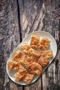 Plateful Of Serbian Traditional Crumpled Cheese Pie Gibanica Set on Old Weathered Cracked Grooved Wooden Garden Table