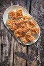 Plateful Of Serbian Traditional Crumpled Cheese Pie Gibanica Set on Old Weathered Cracked Grooved Wooden Garden Table