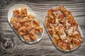 Plateful of Serbian Traditional Crumpled Cheese Pie Gibanica and Spit Roasted Pork Meat Slices Set on Old Weathered Garden Table