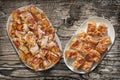 Plateful of Serbian Traditional Crumpled Cheese Pie Gibanica and Spit Roasted Pork Meat Slices Set on Old Weathered Garden Table