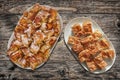 Plateful of Serbian Traditional Crumpled Cheese Pie Gibanica and Spit Roasted Pork Meat Slices Set on Old Weathered Garden Table