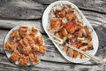 Plateful Of Spit Roasted Pork Shoulder And Serbian Traditional Crumpled Cheese Pie Gibanica Slices Set On Old Wooden Picnic Table