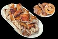 Plateful Of Spit Roasted Pork Slices And Pretzel With Bunch Of Croissant Sesame Cheese Puff Pastry Isolated on Black Background