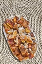 Plateful Of Spit Roasted Pork Slices Set On Rough Rustic Raffia Woven Place Mat