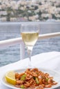 Plateful of Symi Shrimp Served ith a Slice of Lemon and a Glass of Greek White Wine Royalty Free Stock Photo