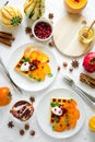 Plates of Belgian waffles with persimmon, pomegranate seeds and sour cream Royalty Free Stock Photo