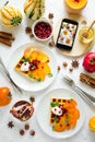 Plates of Belgian waffles with persimmon, pomegranate seeds and sour cream Royalty Free Stock Photo