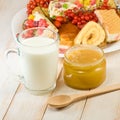 Plates with cookies, cup with milk and honey Royalty Free Stock Photo