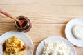 Plates with curd pancakes, soft cheese, fresh curd and plum jam are standing on wooden table and copy space. Royalty Free Stock Photo