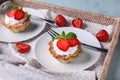 Plates with delicious tartlets in wicker tray