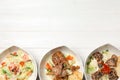 Plates with different tasty salads on white wooden table Royalty Free Stock Photo