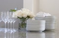 Plates, glasses & roses on the counter Royalty Free Stock Photo