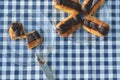 Plates of mini eclairs on checked tablecloth Royalty Free Stock Photo