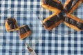 Plates of mini eclairs on checked tablecloth Royalty Free Stock Photo