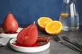 Plates with red wine poached pears and spices served on table Royalty Free Stock Photo