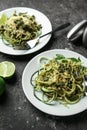 Plates of spaghetti with zucchini, pesto sauce and cheese on table Royalty Free Stock Photo