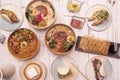 Plates of typical Korean and Japanese food with lots of ramen, noodles, gyozas, bao bread sandwiches, crabs and radishes