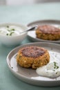2 Plates with vegetarian oatmeal cottage cheese patty with herbal quark dip