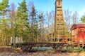 Platform car coupled to a freight car on disused tracks at old train station Royalty Free Stock Photo