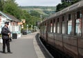 Platform guard checking the train carriages at Grosmont Station, North Yorkshire, the UK Royalty Free Stock Photo