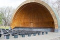 a platform for performing in the form of a wooden arch with benches in the park