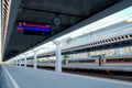 The platform of the railway station is decorated in a modern architectural style. Carriages are lined up along the Royalty Free Stock Photo