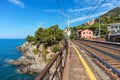 Platform and railroad tracks along Mediterranean sea in Italy. Royalty Free Stock Photo