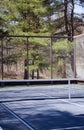 Platform tennis paddle court woods in suburban setting private club