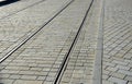 Tram tracks in smooth cobblestone pavement light color gray brown beige granite