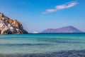 Plathiena beach with cliffs, island and a Yacht