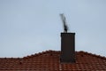 Plating the chimney on the roof of burnt tiles. chimney protection against rain, frost and snow with a brown plate. The tinsmith c Royalty Free Stock Photo