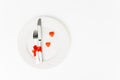 Plating contains fork and knife near lollipops