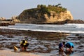 Plating a sand in Klayar Beach, Pacitan