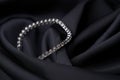 Platinum bracelet with diamonds on black silk background Royalty Free Stock Photo