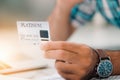 Platinum credit card in hand with background of blured laptop keyboard Royalty Free Stock Photo