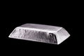 Platinum ingot or bar, noble metal, used in the production of catalysts, luxury jewelry, isolated black background Royalty Free Stock Photo