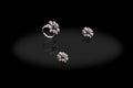 Platinum precious earrings ring flower female with diamonds on black background. Royalty Free Stock Photo