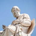 Plato, the ancient Greek philosopher white marble statue on sky background.
